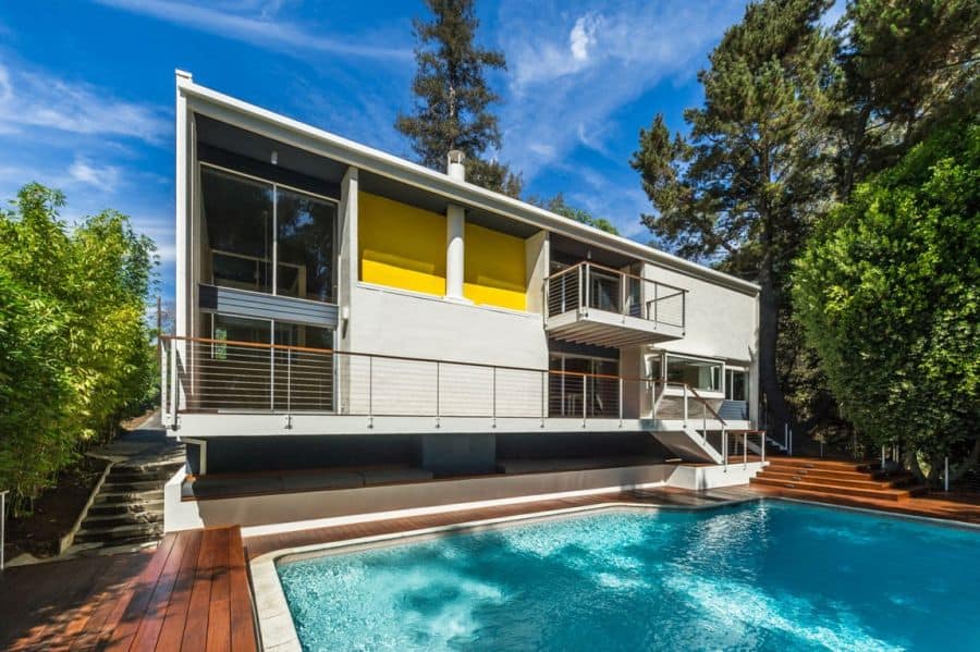 Bakyard with wood deck and a pool Renovated LA Residence Inspired By Its Mid Century Modern Roots