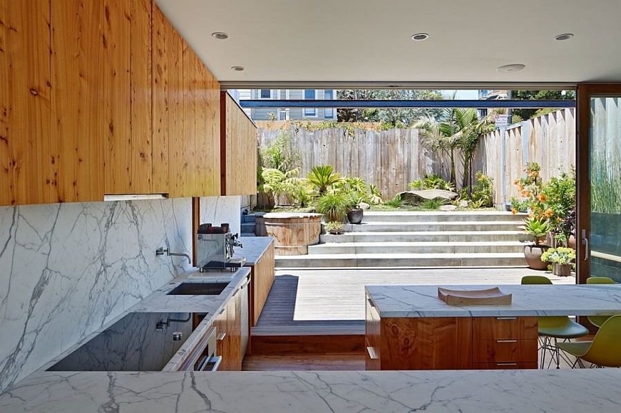 Beautiful marble backsplash and coutertop for the kitchen along with wooden cabinets