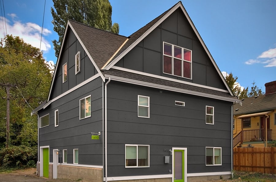 Bright green doors complement the sophisticated gray exterior elegantly