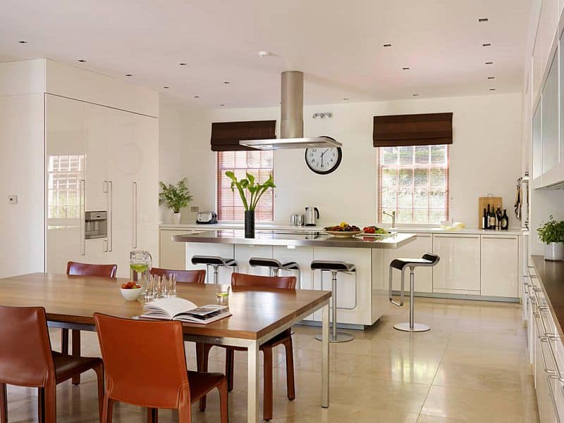 Stainless steel kitchen island with ample seating around it