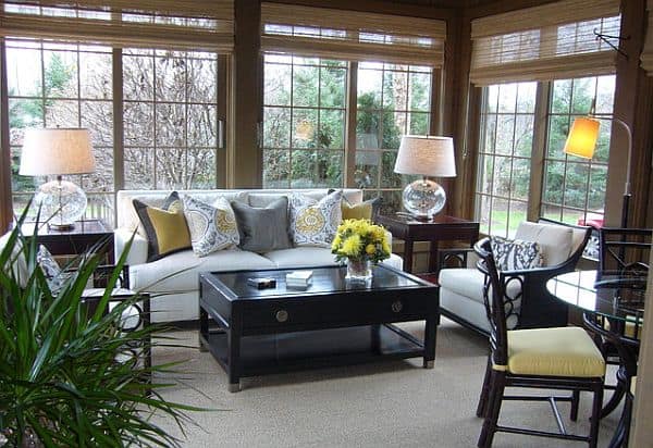 Cozy sunroom design with couch and coffee table cozy sunroom