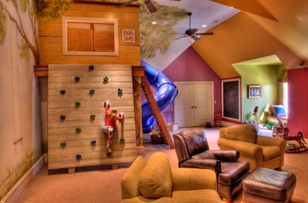 Elaborate playroom with a super slide and a climbing wall 40 Kids Playroom Design Ideas That Usher In Colorful Joy!