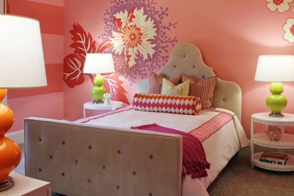 Flower mural perfectly blends pink, red, purple and green in this compact girls' bedroom