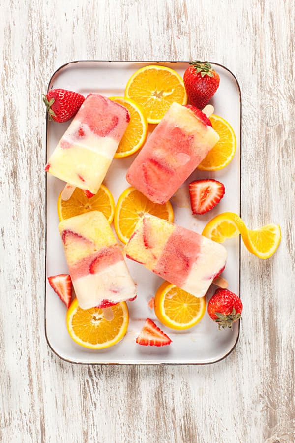 Tasty strawberry orange popsicles