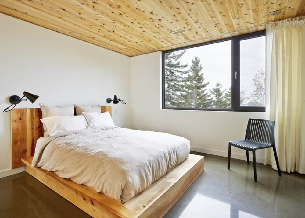 Bedroom Bedroom Reinterpretation of a Traditional Barn: Malbaie VIII Residence in Canada