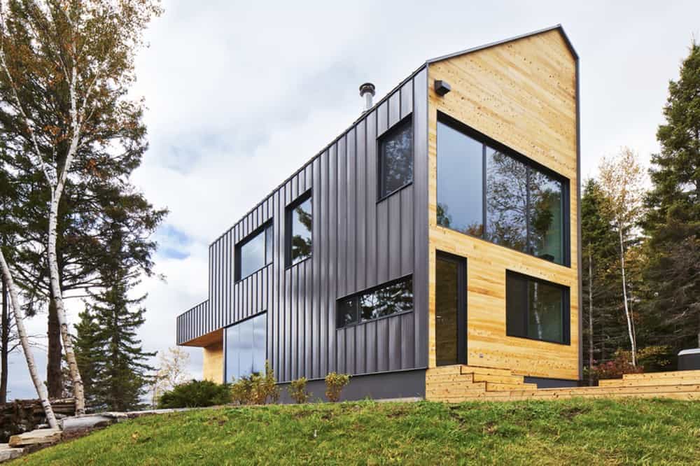 Wood and vertical cladding Wood and vertical cladding Reinterpretation of a Traditional Barn: Malbaie VIII Residence in Canada